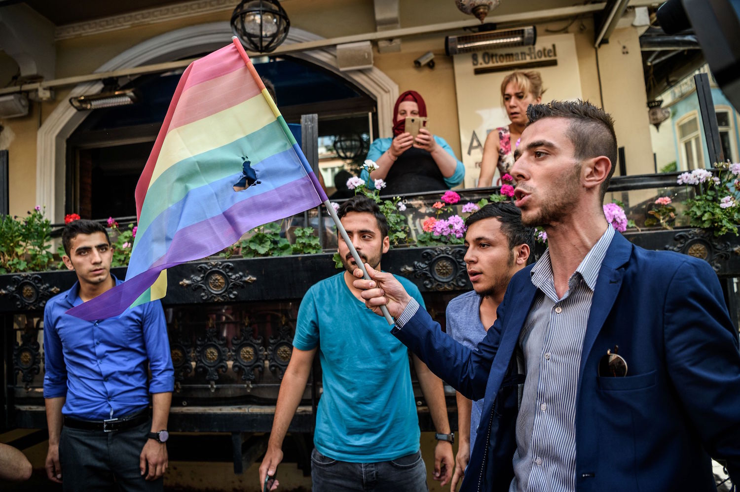 Turkish nationalists burn a rainbow flag during a rally staged by the LGBT community on Istiklal avenue in Istanbul on June 19, 2016. Turkish riot police fired rubber bullets and tear gas to break up a rally staged by the LGBT community in Istanbul on June 19 in defiance of a ban. Several hundred police surrounded the main Taksim Square -- where all demonstrations have been banned since 2013 -- to prevent the "Trans Pride" event taking place during Ramadan.  / AFP / OZAN KOSE        (Photo credit should read OZAN KOSE/AFP/Getty Images)